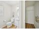Small bathroom with toilet, pedestal sink, and closet at 231 Silver Fox Trl, Dallas, GA 30157