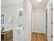 Bathroom featuring modern vanity with brushed nickel hardware and adjacent hallway at 231 Silver Fox Trl, Dallas, GA 30157