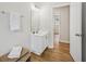 Bright bathroom features a white vanity, framed mirror, and wood-look flooring at 231 Silver Fox Trl, Dallas, GA 30157