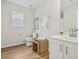 This bathroom offers wood look floors, white vanity, and tiled walls at 231 Silver Fox Trl, Dallas, GA 30157