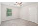 Simple bedroom with neutral carpet, ceiling fan, and natural light at 231 Silver Fox Trl, Dallas, GA 30157