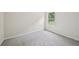 Bedroom featuring neutral carpet and walls, and a window overlooking the yard at 231 Silver Fox Trl, Dallas, GA 30157
