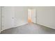Bedroom with two closets and an open door to another room, showing neutral carpet at 231 Silver Fox Trl, Dallas, GA 30157