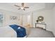 This bedroom features a neutral palette, tray ceiling with fan, and doorway to walk-in closet at 231 Silver Fox Trl, Dallas, GA 30157