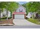 Charming two-story home featuring a two-car garage, red roof, and manicured front yard at 231 Silver Fox Trl, Dallas, GA 30157