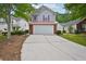 Charming two-story home featuring a two-car garage, red roof, and landscaped front yard at 231 Silver Fox Trl, Dallas, GA 30157