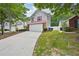 Two-story home with a two-car garage, red roof, and long driveway with small front yard at 231 Silver Fox Trl, Dallas, GA 30157
