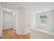 Bright hallway featuring hardwood floors, white trim, and natural light from the window at 231 Silver Fox Trl, Dallas, GA 30157