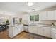 Bright kitchen with white cabinets, granite countertops, and stainless steel appliances at 231 Silver Fox Trl, Dallas, GA 30157