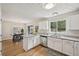 Bright kitchen with white cabinets, granite countertops, and stainless steel appliances at 231 Silver Fox Trl, Dallas, GA 30157