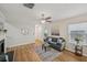 Bright living room featuring hardwood floors, a ceiling fan, and neutral wall color at 231 Silver Fox Trl, Dallas, GA 30157
