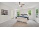 Main bedroom with tray ceiling, two windows, and soft carpet at 231 Silver Fox Trl, Dallas, GA 30157