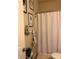 Neutral-toned bathroom with shower-tub combo, decorative shower curtain, and artwork at 2979 Dungeness Dr, Douglasville, GA 30135
