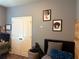 Bedroom with grey walls, carpet, closet, headboard, and abstract art on the walls at 2979 Dungeness Dr, Douglasville, GA 30135