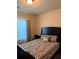 Bedroom features a leopard-print bedspread, a patterned headboard, and natural light at 2979 Dungeness Dr, Douglasville, GA 30135