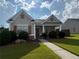 Inviting single-story home featuring a covered entryway and lush, green landscaping at 2979 Dungeness Dr, Douglasville, GA 30135