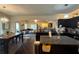 Open-concept kitchen with a large center island, granite countertops, and dark wood cabinetry at 2979 Dungeness Dr, Douglasville, GA 30135