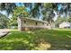 Exterior side of home with large backyard and mature trees at 338 Patterson Rd, Lawrenceville, GA 30044