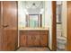 This bathroom has vanity with drawers, a decorative mirror, and a toilet at 338 Patterson Rd, Lawrenceville, GA 30044