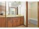 This bathroom has vanity with drawers, a decorative mirror, a toilet, and a bathtub at 338 Patterson Rd, Lawrenceville, GA 30044