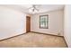 This bedroom has a ceiling fan, a window, and a wooden door at 338 Patterson Rd, Lawrenceville, GA 30044