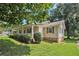 Side view of a charming one story home with a well-maintained lawn, shrubbery, and landscaping at 338 Patterson Rd, Lawrenceville, GA 30044