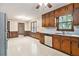 Kitchen area featuring wood cabinets, white countertops, vinyl flooring, and an attached eating area at 338 Patterson Rd, Lawrenceville, GA 30044