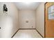 This laundry room has a tile floor, a window, and is well-lit at 338 Patterson Rd, Lawrenceville, GA 30044