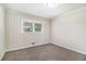 The cozy bedroom boasts a ceiling light, neutral paint, and new carpet at 41 Elder St, Fairburn, GA 30213