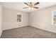Cozy bedroom showcasing plush carpet, neutral walls, and a ceiling fan for added comfort at 41 Elder St, Fairburn, GA 30213