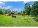 Large backyard featuring a playset, bench, and green grass at 1198 Old Mill Rd, Dallas, GA 30157