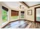 Bright dining area with wood floors, large windows, and modern light fixture at 1198 Old Mill Rd, Dallas, GA 30157