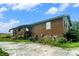 Spacious home exterior with stone foundation and landscaped yard at 1198 Old Mill Rd, Dallas, GA 30157