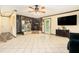 Bright living room featuring a stone fireplace, tile floors, and a ceiling fan at 1198 Old Mill Rd, Dallas, GA 30157