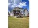 Large backyard with a covered deck, stairs and lush green lawn at 312 Archway Ln, Peachtree City, GA 30269