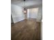 Open dining area shows a stylish chandelier, hardwood floors, and neutral walls at 312 Archway Ln, Peachtree City, GA 30269