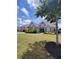 Beautiful home exterior with an expansive green lawn and manicured bushes at 312 Archway Ln, Peachtree City, GA 30269