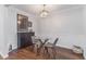 Dining room features a glass table, modern lighting, and hardwood floors at 5149 Roswell Rd # 1, Atlanta, GA 30342