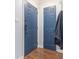 Stylish entryway with blue doors, modern hardware, and wood floors provides practical storage at 5149 Roswell Rd # 1, Atlanta, GA 30342