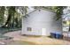 Back exterior with a gray facade, a window and white door, in addition to a small patio at 733 Emerald Forest Cir, Lawrenceville, GA 30044