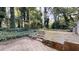 View of the backyard featuring mature trees and stone stairs leading to an upper tier at 733 Emerald Forest Cir, Lawrenceville, GA 30044