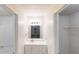 Bright bathroom featuring a modern vanity with a sleek mirror and a three-light fixture at 733 Emerald Forest Cir, Lawrenceville, GA 30044