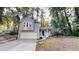 Charming two-story home with a well-maintained front yard and attached garage nestled among mature trees at 733 Emerald Forest Cir, Lawrenceville, GA 30044