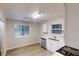 Well-lit kitchen with white cabinets, stainless steel appliances, hardwood floors and double sink at 733 Emerald Forest Cir, Lawrenceville, GA 30044