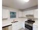 Bright kitchen features white cabinets, stainless steel appliances, and a double-bowl sink at 733 Emerald Forest Cir, Lawrenceville, GA 30044