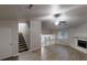 Spacious living room featuring hardwood floors, a fireplace, staircase, and a ceiling fan at 733 Emerald Forest Cir, Lawrenceville, GA 30044