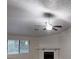 Bright living room with large windows, fireplace, and a ceiling fan creating a cozy atmosphere at 733 Emerald Forest Cir, Lawrenceville, GA 30044