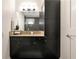 Bathroom with a dark vanity with granite countertop, decorative mirror and a tiled shower at 905 Juniper Ne St # 805, Atlanta, GA 30309