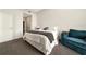 A cozy bedroom with gray carpeting, a large window, and a comfortable couch at 905 Juniper Ne St # 805, Atlanta, GA 30309