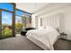 Inviting bedroom with plush bed, city views, and plenty of natural light at 905 Juniper Ne St # 805, Atlanta, GA 30309